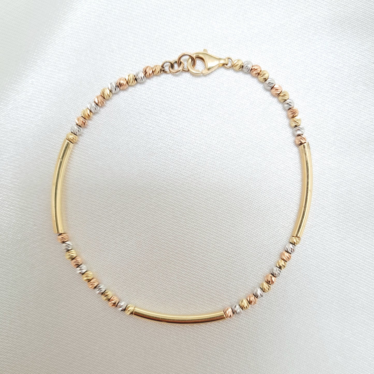 Pulsera con Tubitos y Bolitas en 3 Oros de 14K