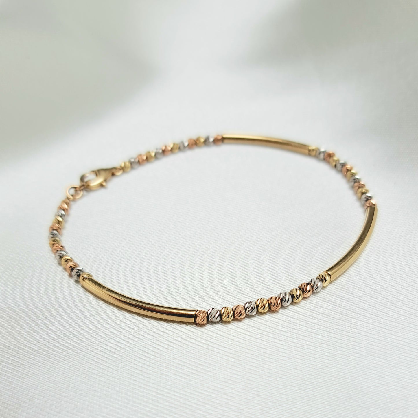Pulsera con Tubitos y Bolitas en 3 Oros de 14K