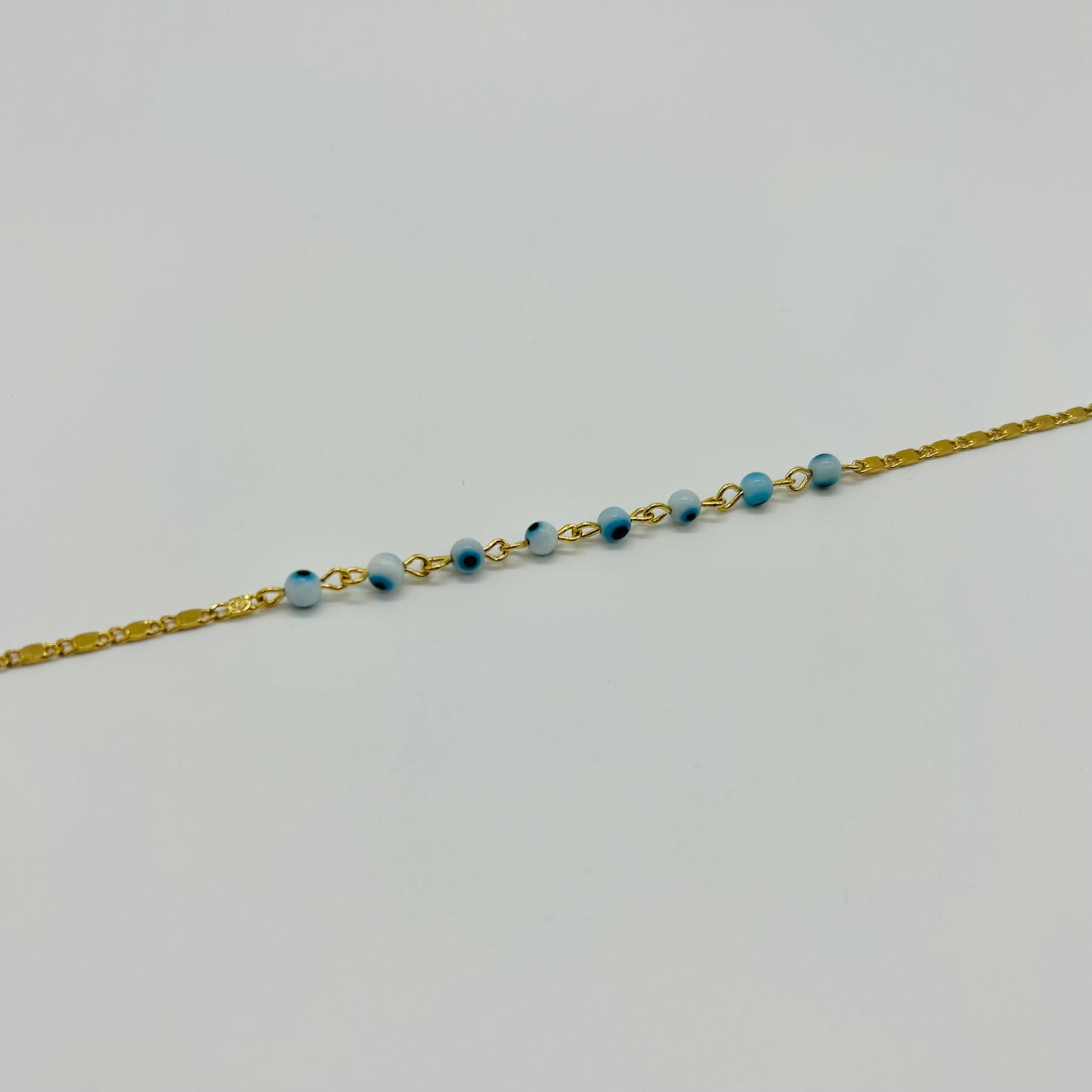 Pulsera de Ojitos Blanco con Azul de Oro Laminado