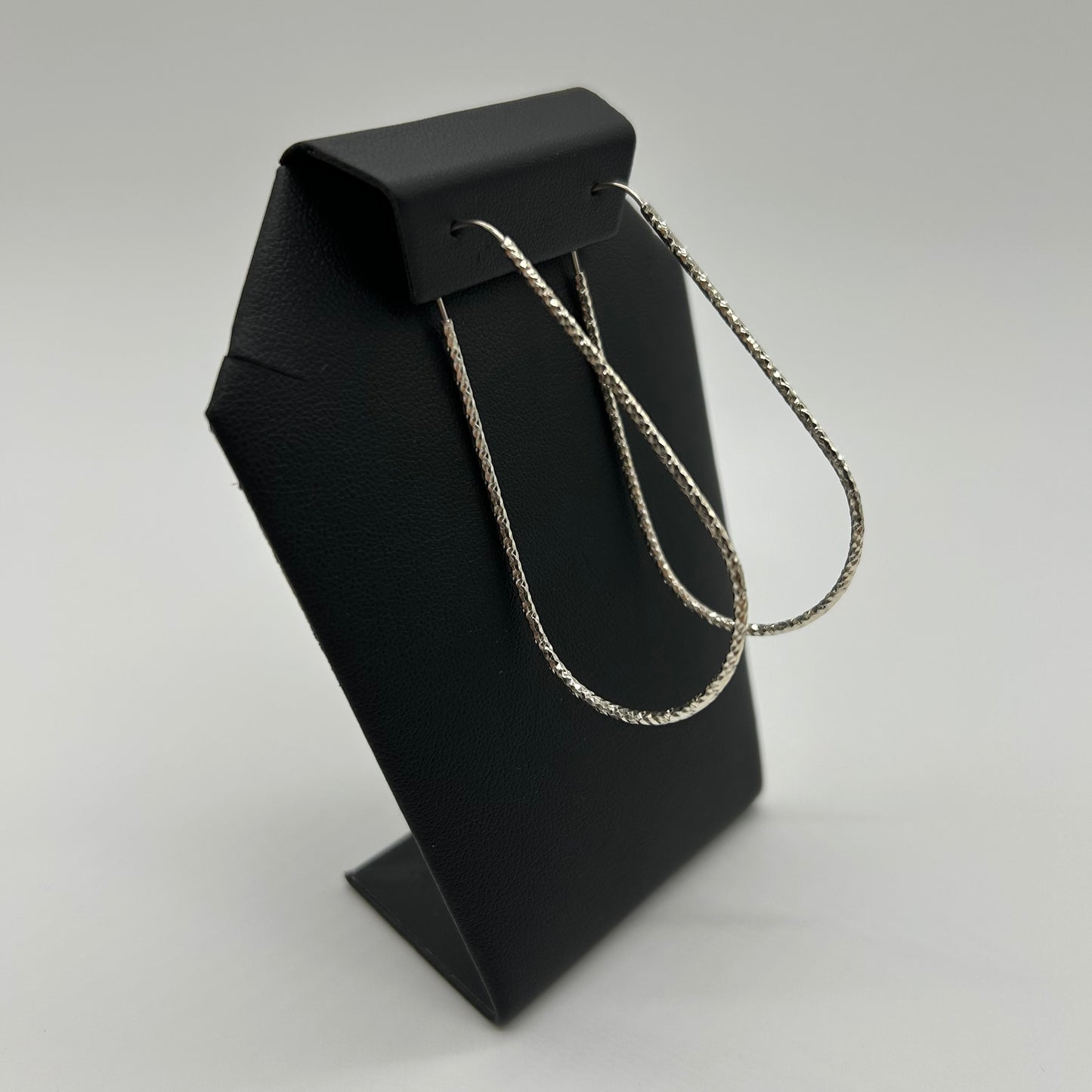 Aretes de Tubo Facetado en Forma de Gota de Plata